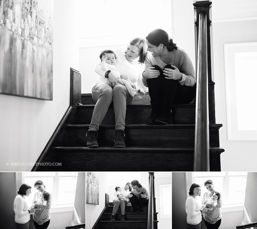 Carrollton family photographer, parents holding baby on stairs