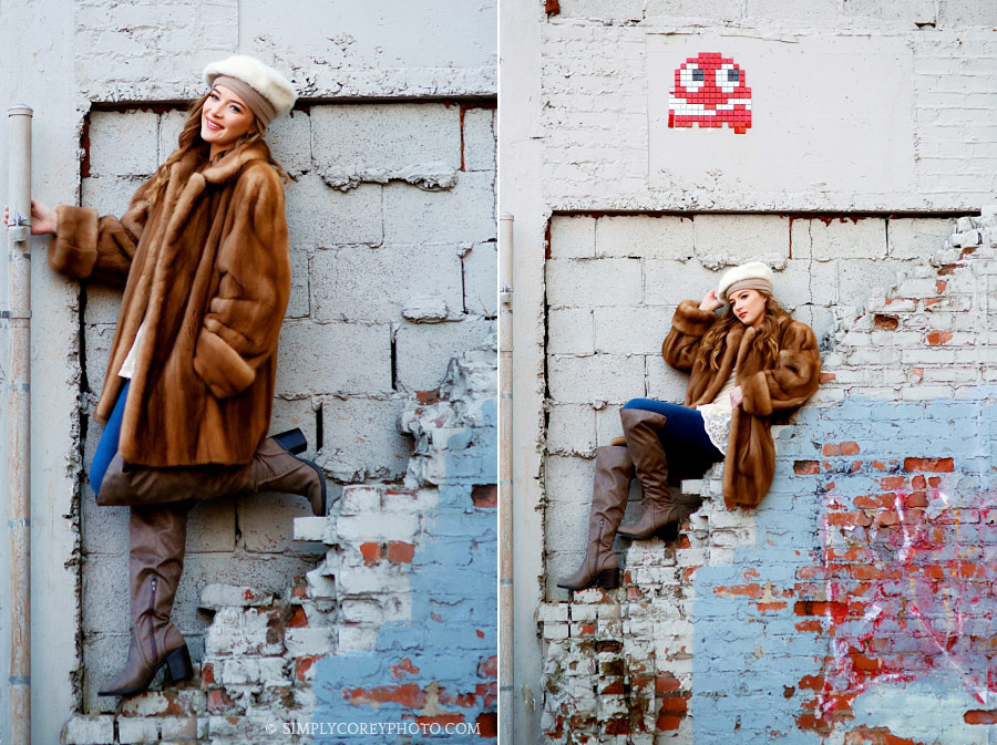 Carrollton senior portraits of a teen in fur by a brick wall downtown