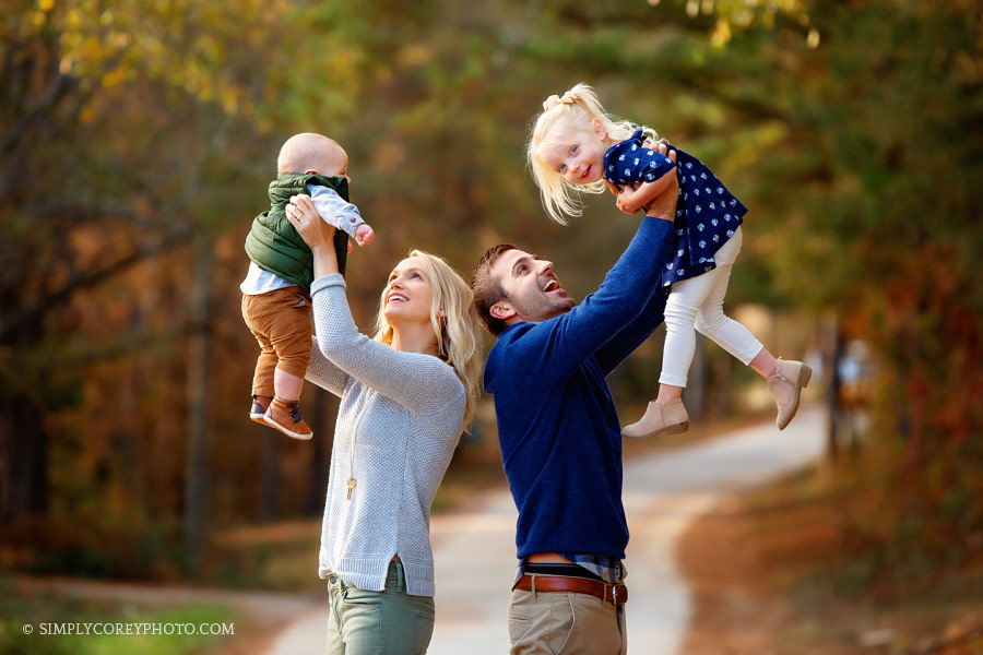 Douglasville family photographer, parents playing with two kids outside