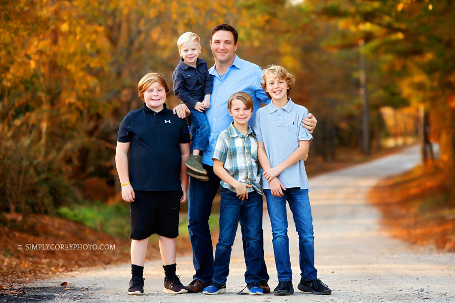 Newnan family photographer, dad and four boys on a country road in the fall