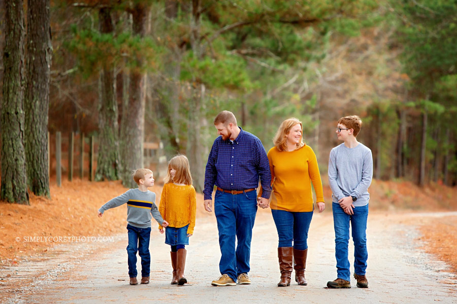 Atlanta family photographer, couple with three kids walking on country road