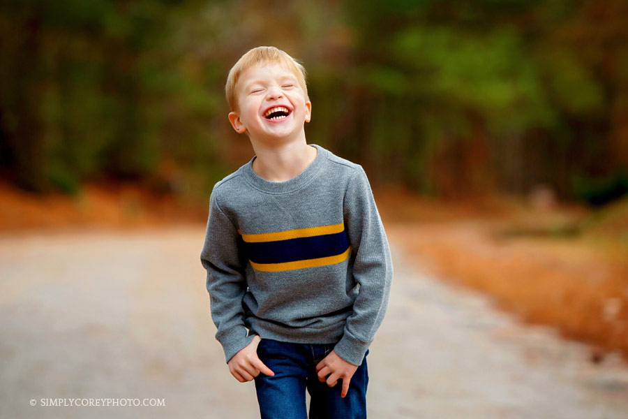 Newnan photographer, child laughing outside on a country road