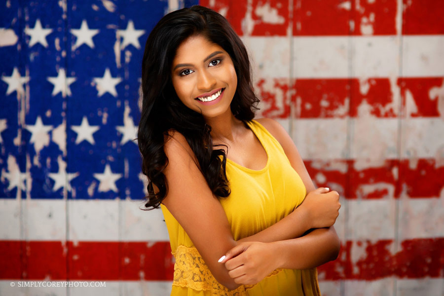 Villa Rica senior portrait photographer, teen on American flag backdrop