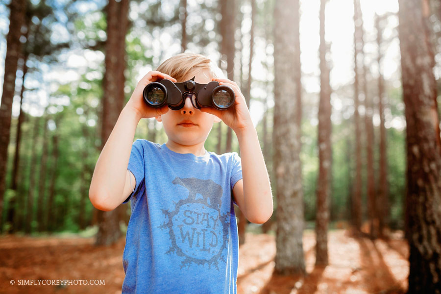Atlanta commercial photographer, child model exploring outdoors with binoculars