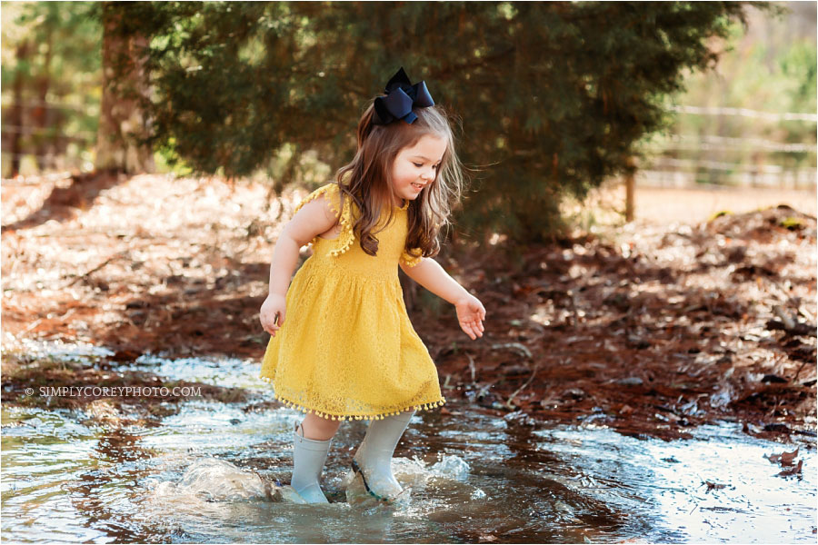 Atlanta lifestyle photographer, child jumping in rain puddles