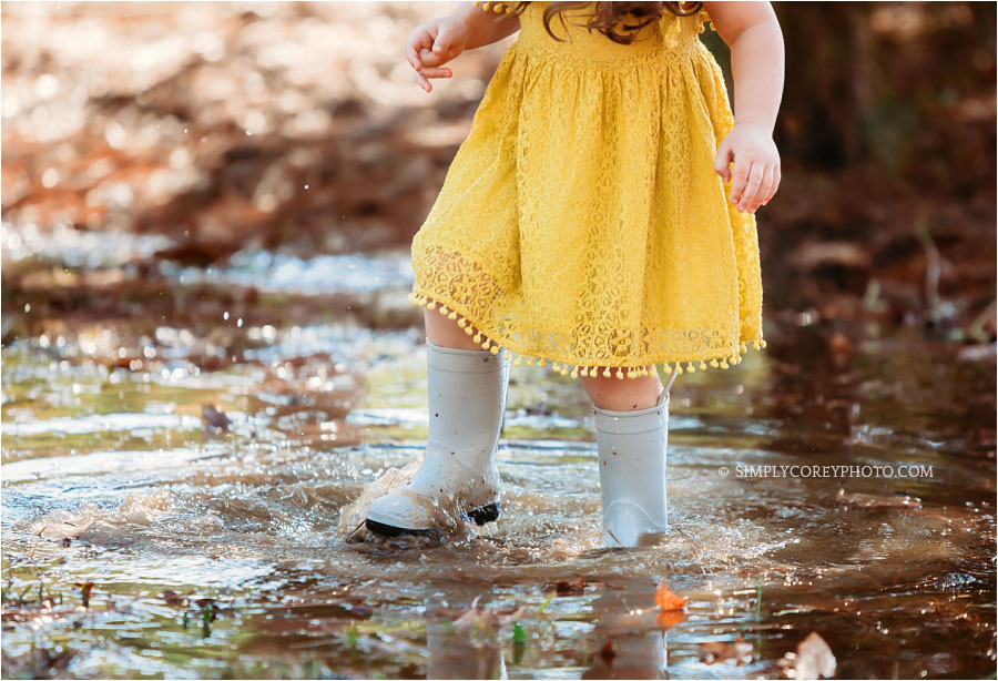 Carrollton lifestyle photographer, child in rain boots in a puddle