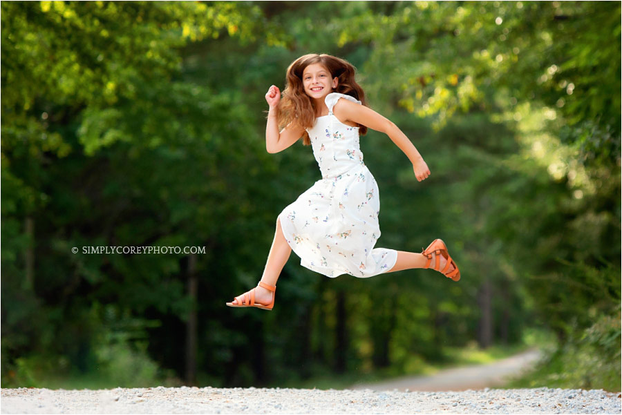 Atlanta children's photographer, tween jumping on country road
