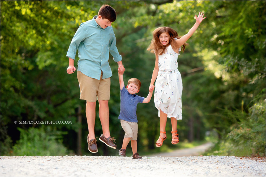 Atlanta family photographer, kids jumping outside on a country road