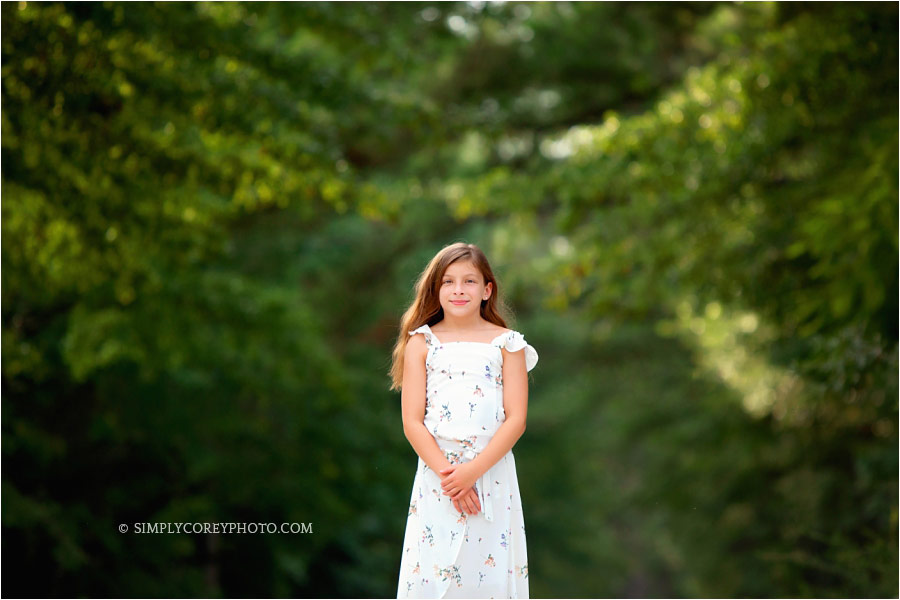 Douglasville photographer, tween girl outside by green trees