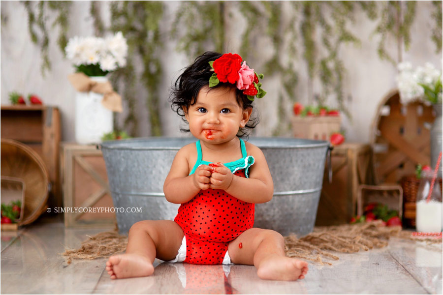 Newnan baby photographer, baby eating strawberries during milestone session