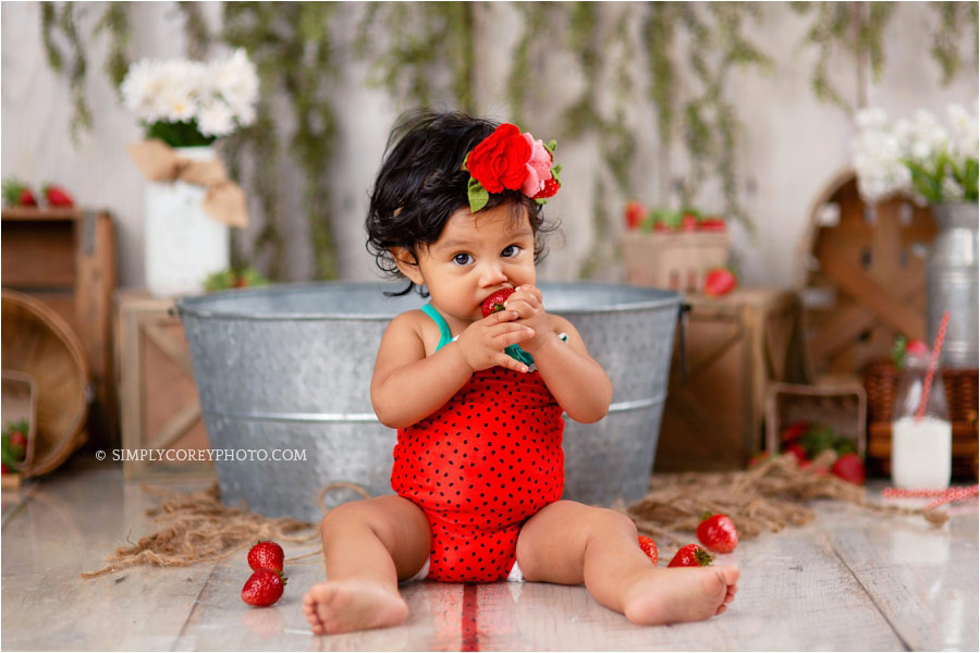 Villa Rica baby photographer, eating strawberries during a milestone session