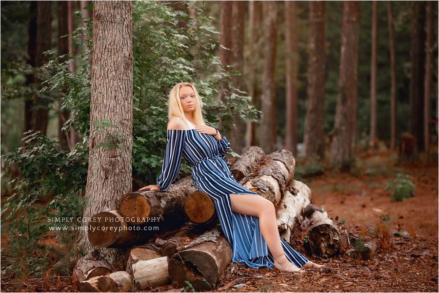 West Georgia senior portrait photographer, teen girl sitting on log pile