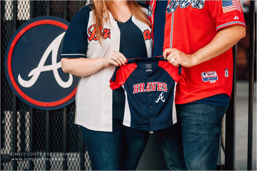 Bremen maternity photographer, couple holding Atlanta Braves onesie