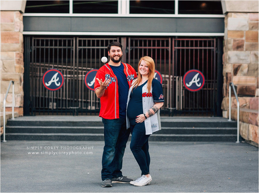 maternity photographer near Atlanta, couple with Braves jerseys and baseball