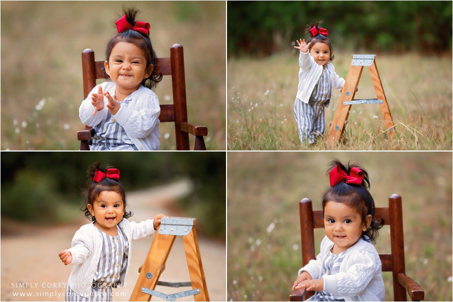 Carrollton baby photographer, girl in a red bow outside in a field