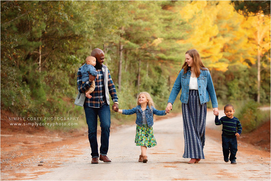 Newnan family photographer, parents with kids and baby on a dirt road