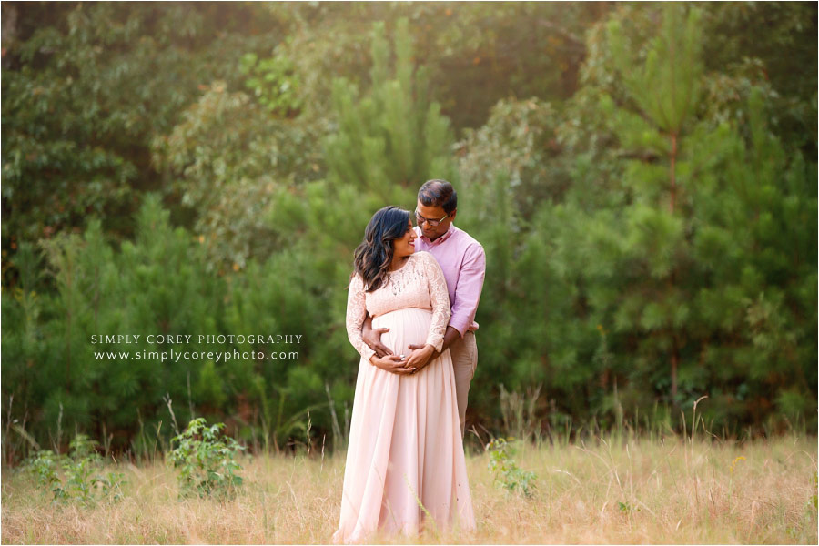 Atlanta maternity photographer, couple in pink outside in a field