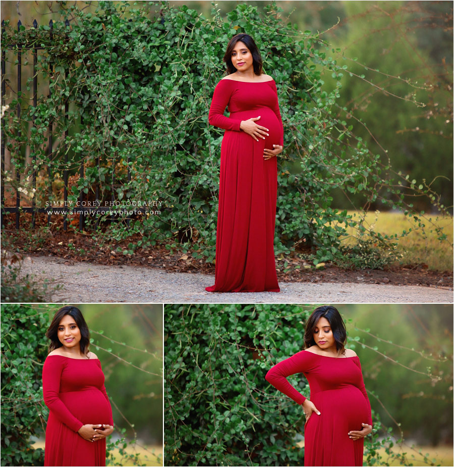 Bremen maternity photographer, pregnant mom in red outside with greenery