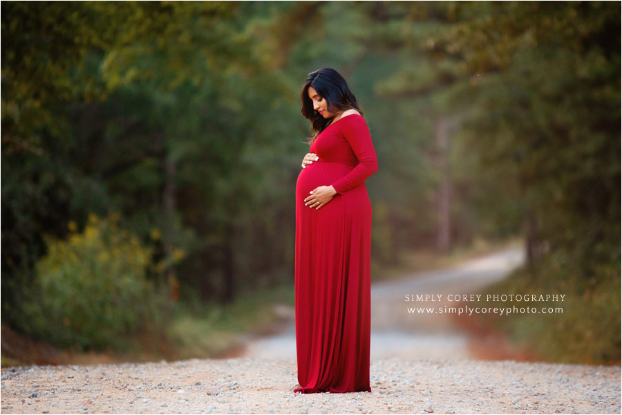 maternity photographer near Carrollton, GA; mom in red on country road