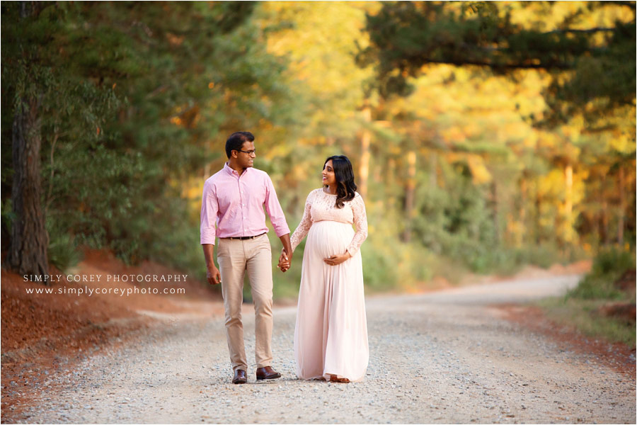 Newnan maternity photographer, couple in pink walking on dirt road