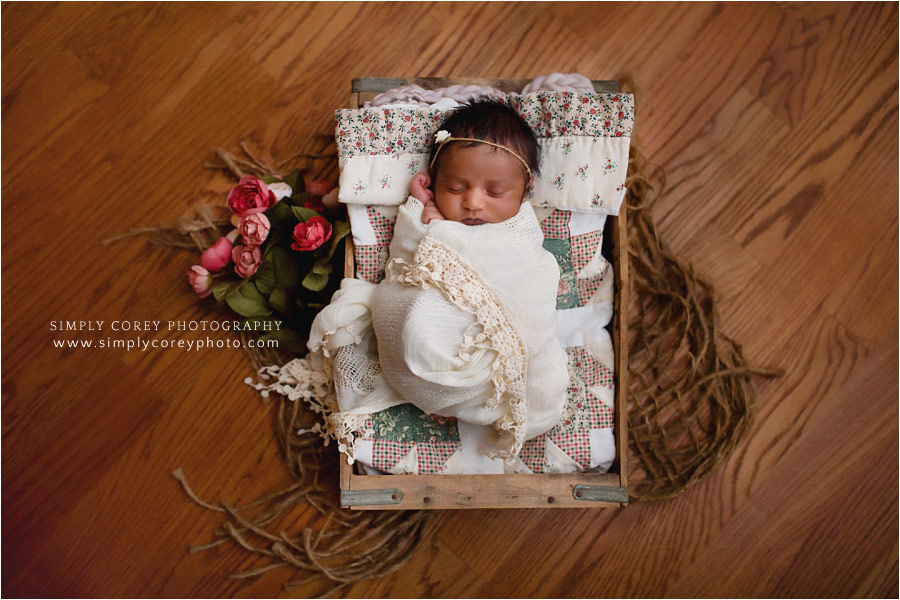 Douglasville newborn photographer, baby girl in lace on a quilt