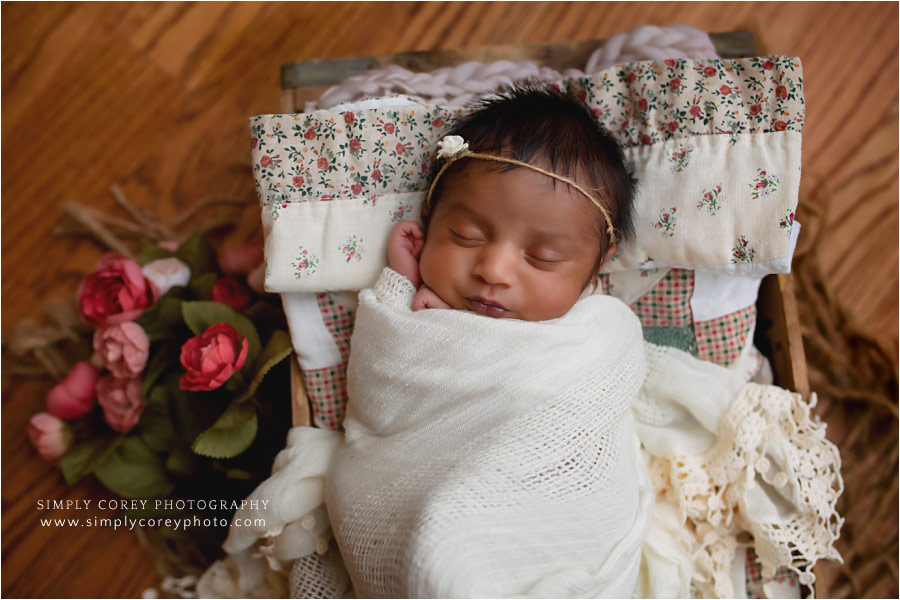 newborn photographer near Newnan, baby girl with flowers and quilt