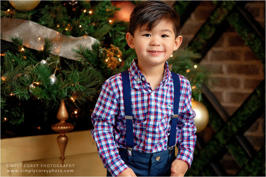 child photographer near Carrollton, GA; boy near Christmas tree