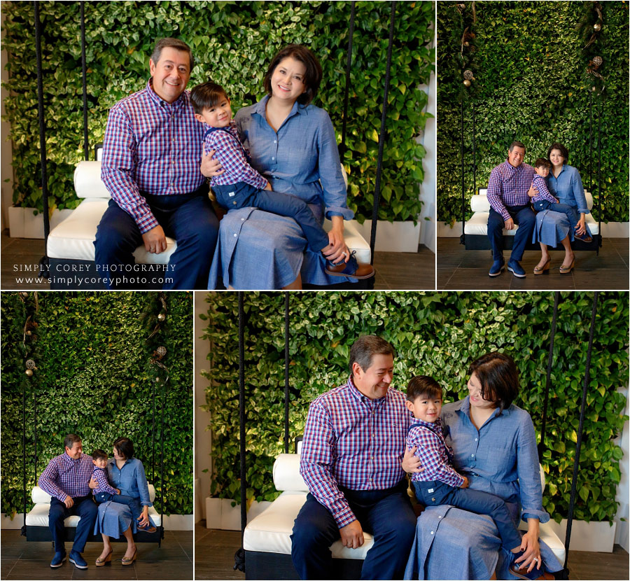 Douglasville family photographer, portraits by greenery wall in Atlanta hotel