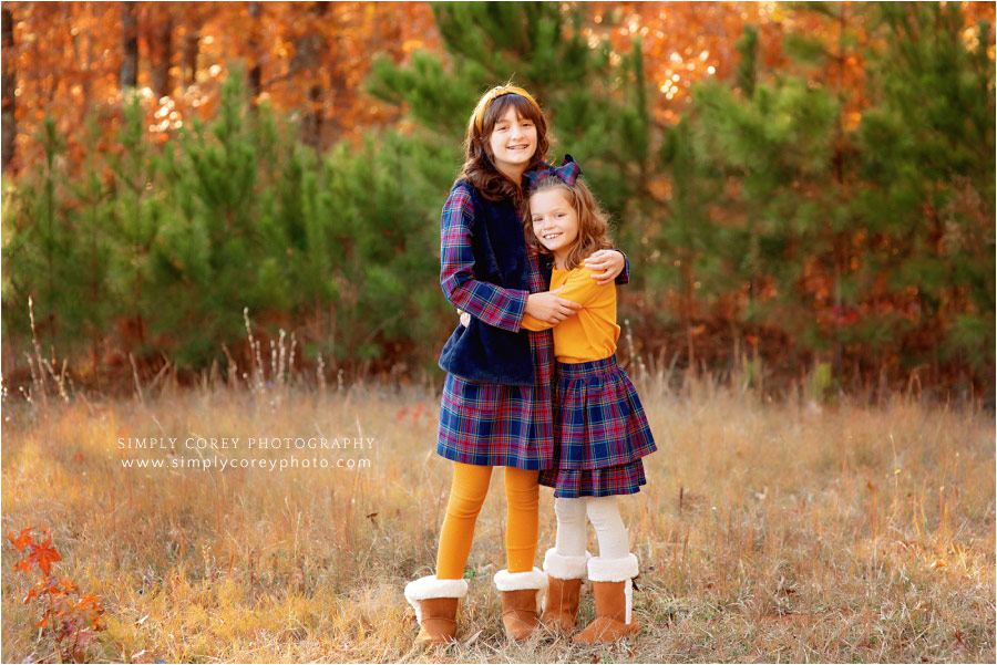 Villa Rica family photographer, children outside in fall by pines