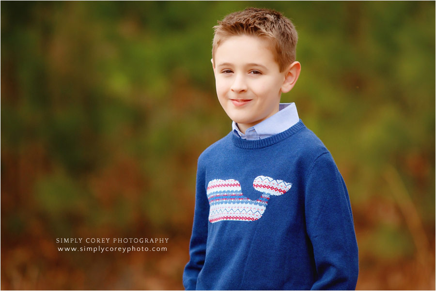 Douglasville children's photographer, outdoor headshot of child in blue sweater