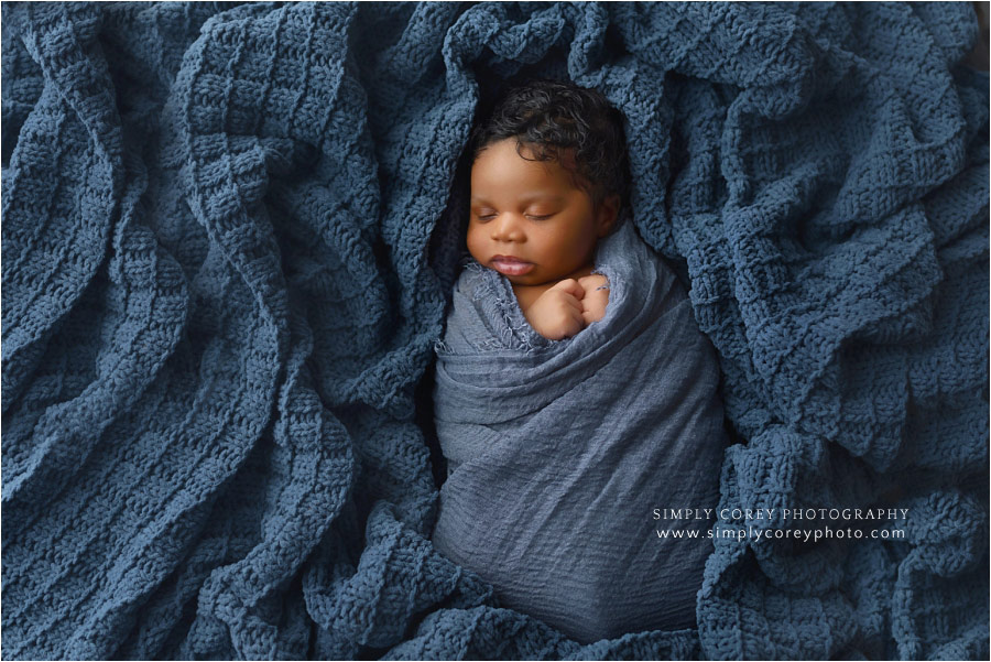 Villa Rica newborn photographer, baby boy in blue blanket