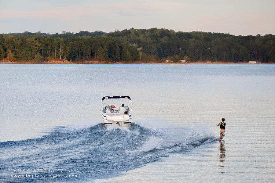 Newnan lifestyle photographer, teen wakeboarding behind boat on Lake Lanier