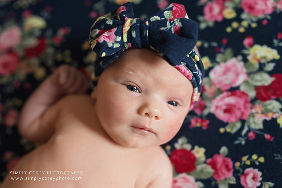 Newnan Fresh 48 photographer, newborn with floral blanket and bow in hospital