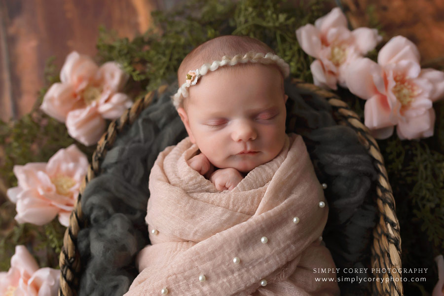 Villa Rica newborn photographer, baby swaddled in a basket with flowers