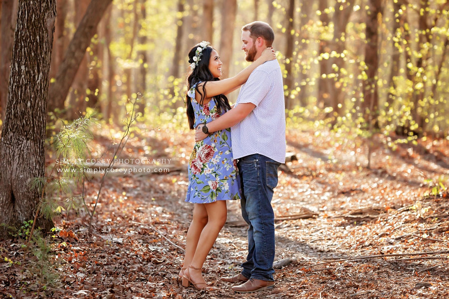 Carrollton maternity photographer, couple facing each other in woods