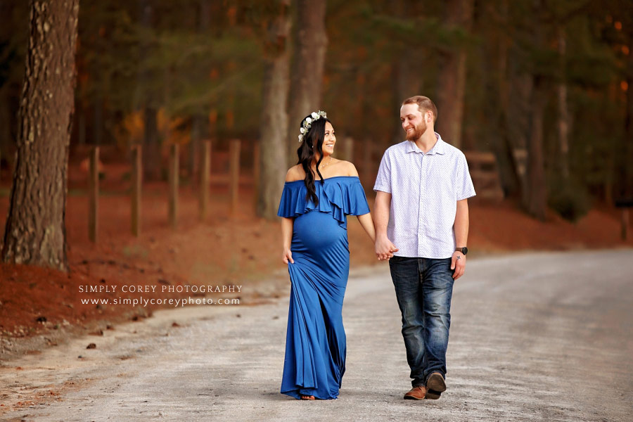 maternity photographer near Atlanta, couple in blue walking on country road