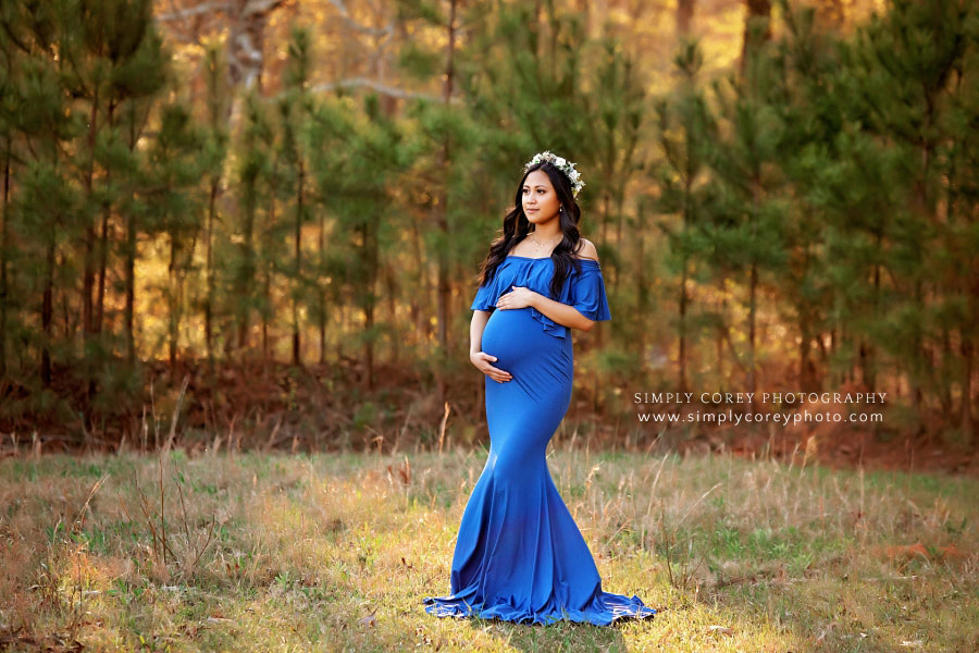 Villa Rica maternity photographer, mom in blue dress and flower crown by pines