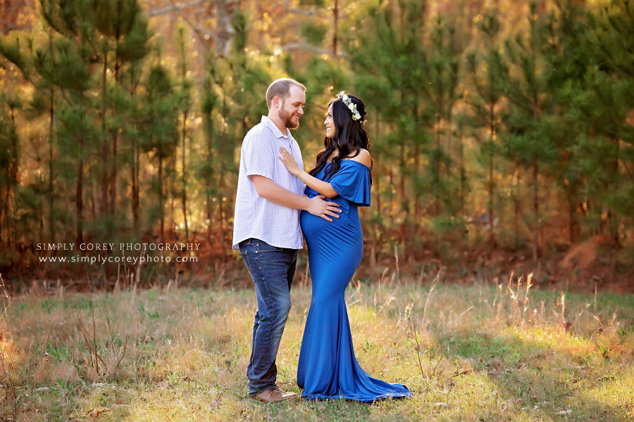 West Georgia maternity photographer, couple outside by pine trees