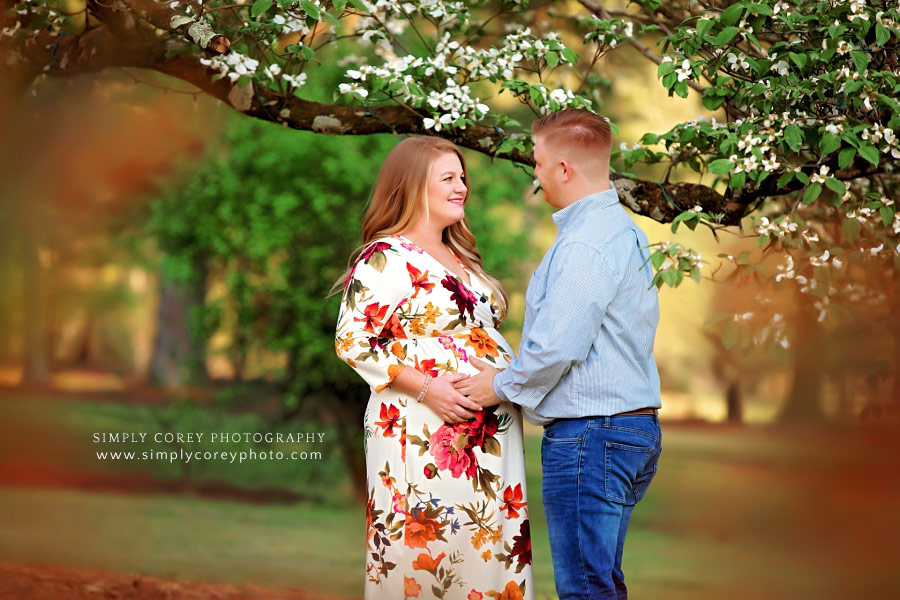 Atlanta maternity photographer, expecting couple by Dogwood tree
