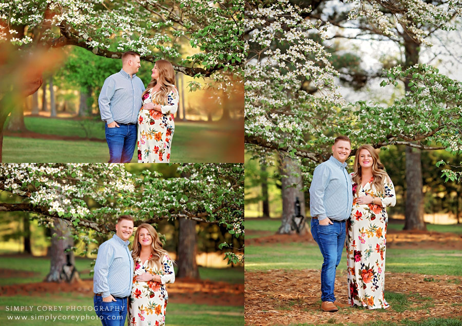 Carrollton maternity photographer, couple by Dogwood tree in spring