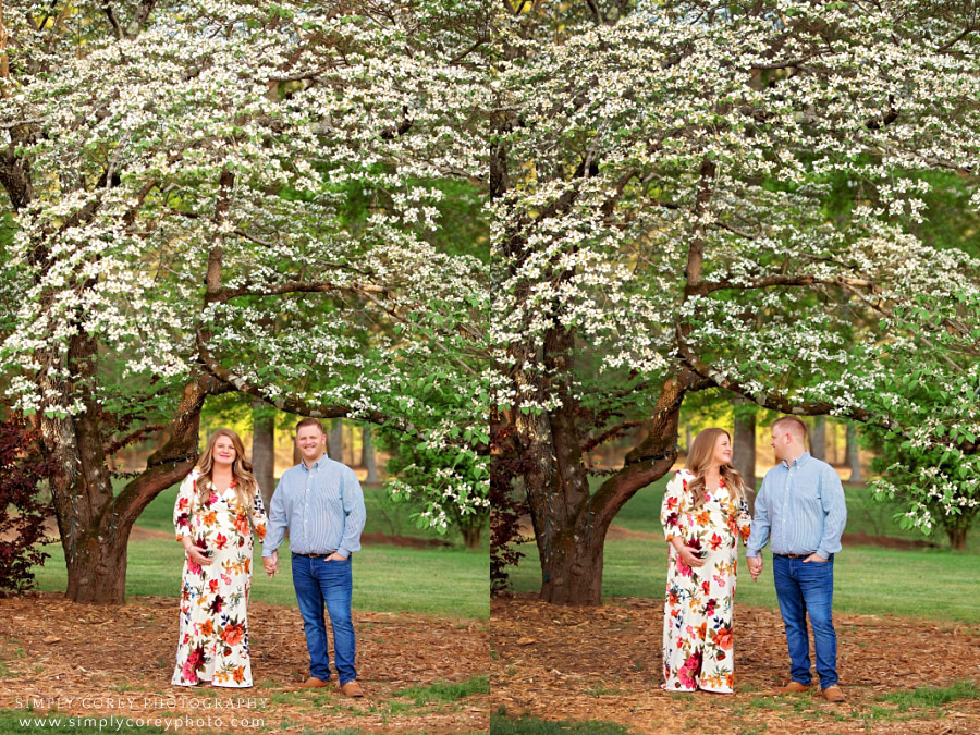 Douglasville maternity photographer, couple by Dogwood tree with spring blossoms