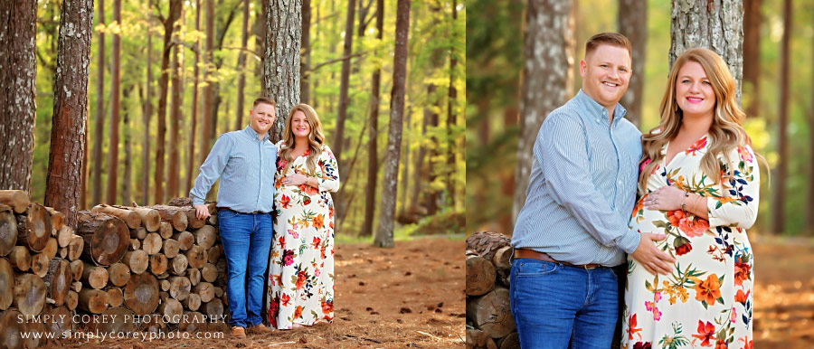 maternity photographer in West Georgia, expecting couple near log wall