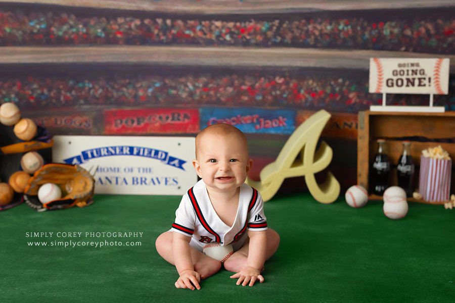 Atlanta baby photographer, big grin during Braves baseball studio session