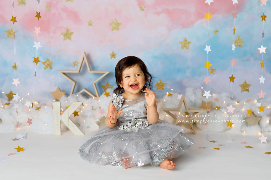 baby photographer near Villa Rica, girl in silver dress laughing during star session