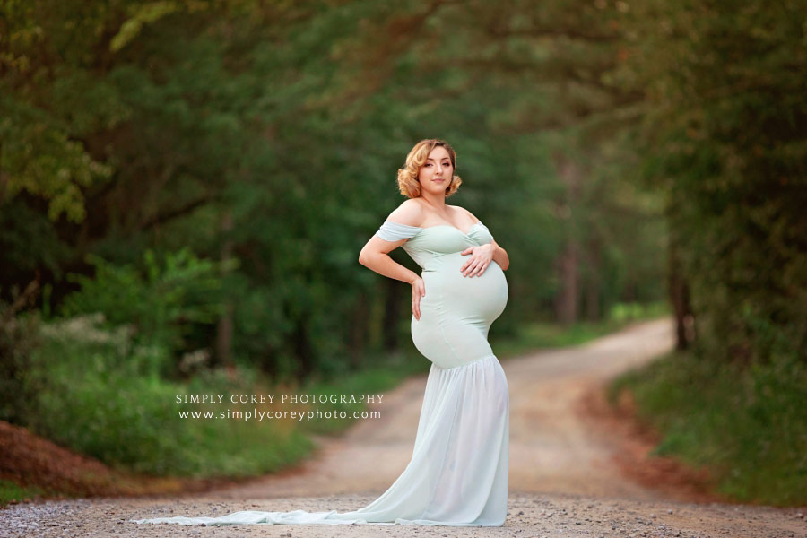maternity photographer near Atlanta, outside on a country road in a flowy green dress