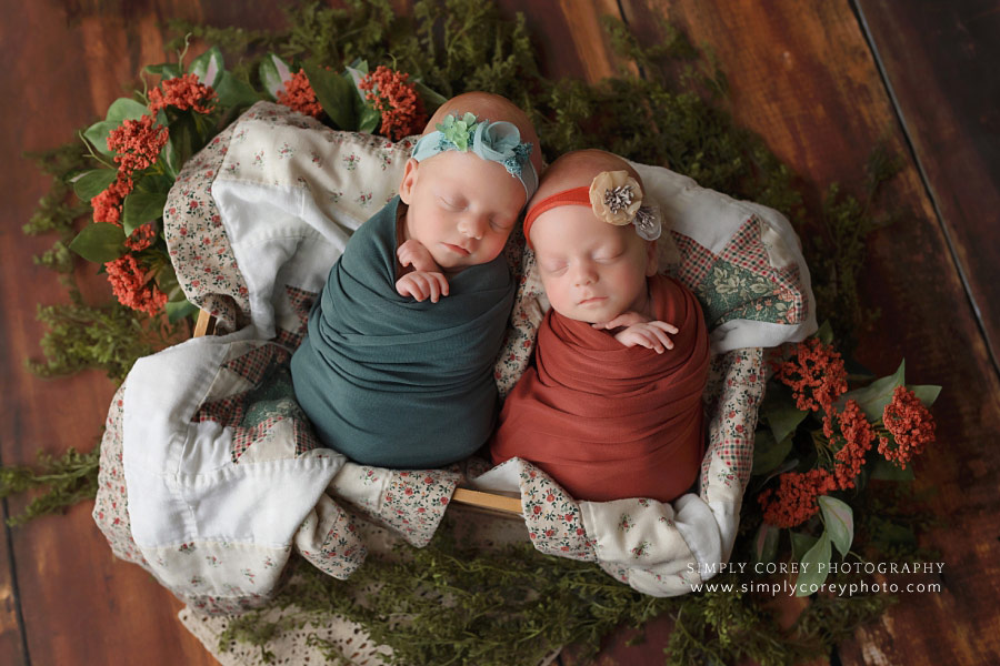 Carrollton newborn photographer, twin baby girls in orange and teal on quilt
