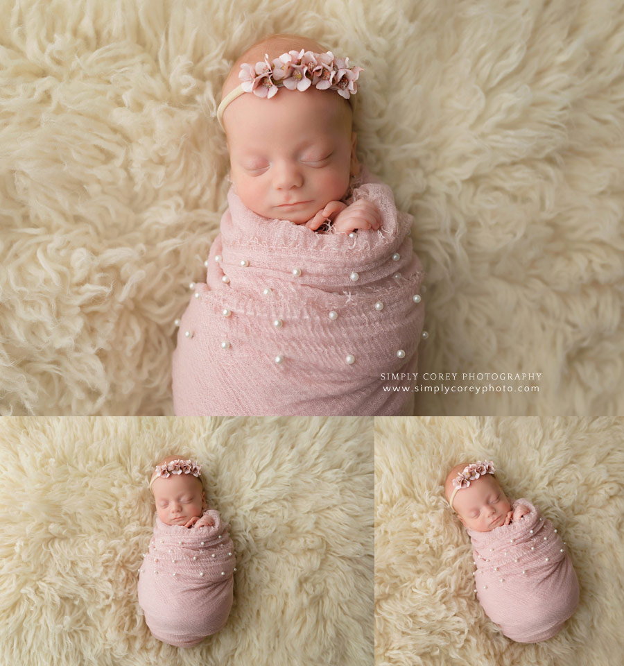 newborn photographer near Villa Rica, baby girl in pink pearl wrap on flokati