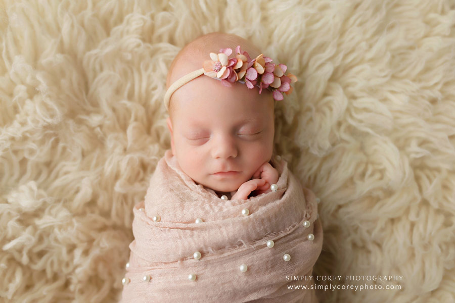 Newnan newborn photographer, baby girl in blush pink wrap on flokati