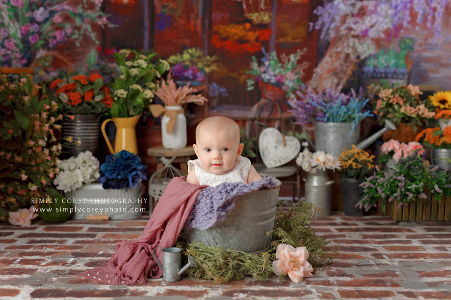baby photographer near Newnan, girl in bucket with flowers for milestone session
