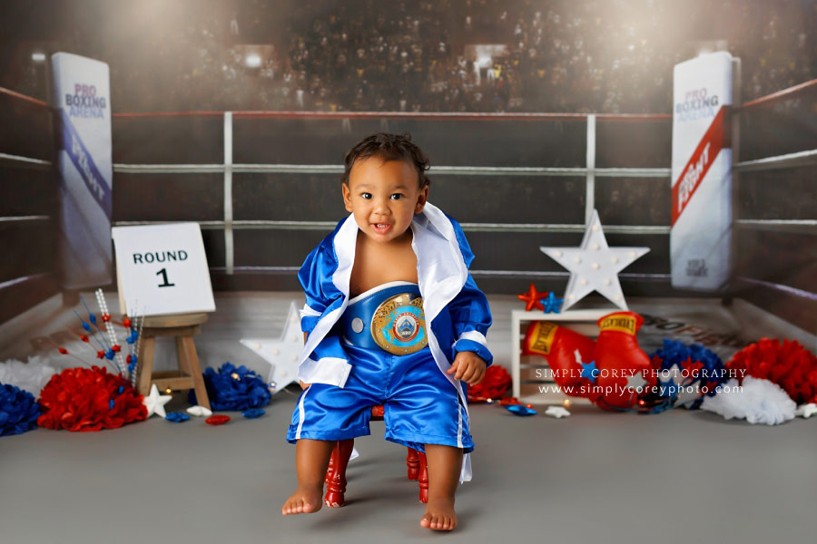 baby photographer near Atlanta, one year old in robe on boxing set